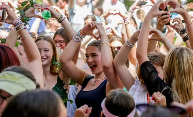 FILE - Fans of Taylor Swift also known as Swifties sing and dance in Vienna, Aug.9, 2024. (AP Photo/Heinz-Peter Bader, File)