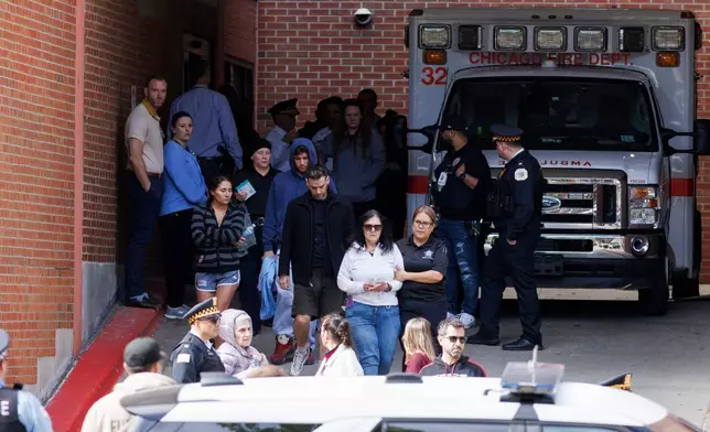 People walk outside of Illinois Masonic Hospital Advance Care in Lake View after a shooting Saturday, April 25, 2026, in Chicago. (Anthony Vazquez/Chicago Sun-Times via AP)