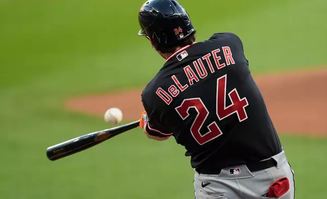 Cleveland Guardians' Chase DeLauter (24) hits a single in the first inning of a baseball game against the Cleveland Guardians, Sunday, April 12, 2026, in Atlanta. (AP Photo/Mike Stewart)