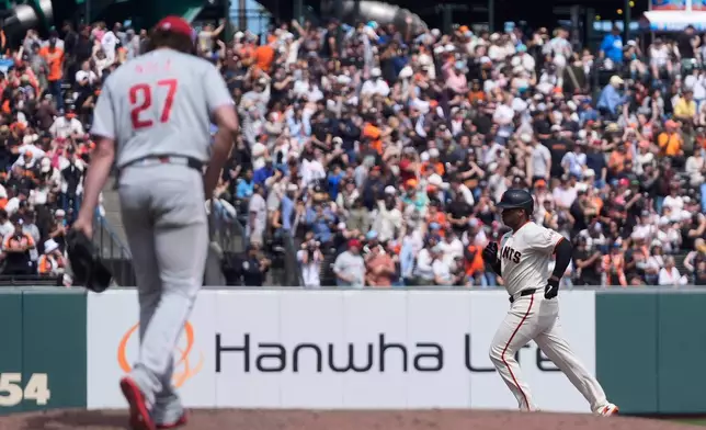 Philadelphia Phillies pitcher Aaron Nola (27) reacts on the mound after allowing a three-run home run to San Francisco Giants' Rafael Devers, right, during the sixth inning of a baseball game in San Francisco, Wednesday, April 8, 2026. (AP Photo/Jeff Chiu)
