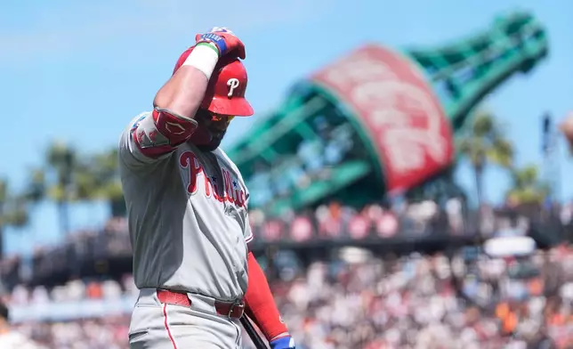 Philadelphia Phillies' Kyle Schwarber walks to the dugout after striking out against the San Francisco Giants during the seventh inning of a baseball game in San Francisco, Wednesday, April 8, 2026. (AP Photo/Jeff Chiu)