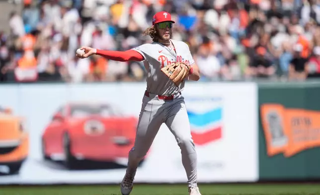 Philadelphia Phillies third baseman Alec Bohm throws out San Francisco Giants' Jerar Encarnacion at first base during the fifth inning of a baseball game in San Francisco, Wednesday, April 8, 2026. (AP Photo/Jeff Chiu)