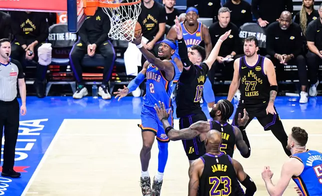 Oklahoma City Thunder guard Shai Gilgeous-Alexander (2) shoots against Los Angeles Lakers forward Jake LaRavia (12) during the second half of an NBA basketball game Thursday, April 2, 2026, in Oklahoma City. (AP Photo/Gerald Leong)
