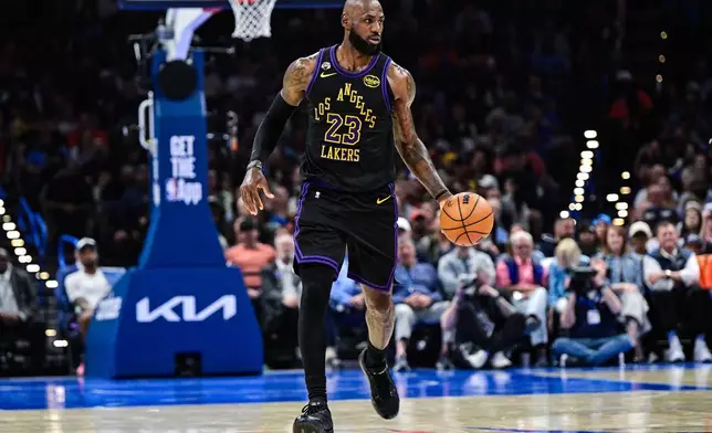 Los Angeles Lakers forward LeBron James (23) drives the ball during the first half of an NBA basketball game against the Oklahoma City Thunder Thursday, April. 2, 2026, in Oklahoma City. (AP Photo/Gerald Leong)