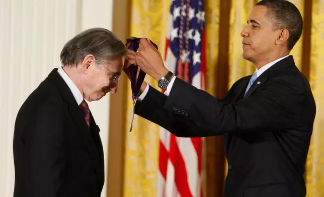 FILE - President Barack Obama presents conductor Michael Tilson Thomas the 2009 National Medal of Arts in the East Room of the White House in Washington on Feb. 25, 2010. (AP Photo/Charles Dharapak, File)