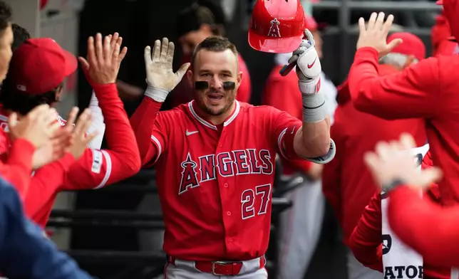 Los Angeles Angels' Mike Trout celebrates in the dugout with teammates after hitting a solo home run during the fourth inning of a baseball game against the Chicago White Sox in Chicago, Wednesday, April 29, 2026. (AP Photo/Nam Y. Huh)