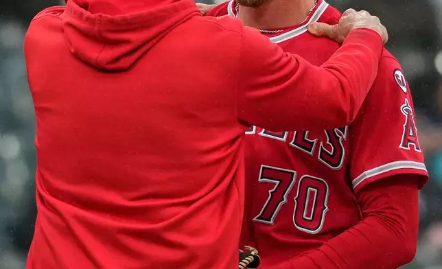 Los Angeles Angels relief pitcher Mitch Farris, right, listens to pitching coach Mike Maddux during the third inning of a baseball game against the Chicago White Sox in Chicago, Wednesday, April 29, 2026. (AP Photo/Nam Y. Huh)