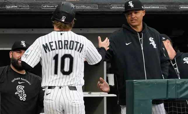 Chicago White Sox manager Will Venable, right, celebrates with Chase Meidroth after he scored on a one-run single by Miguel Vargas during the third inning of a baseball game against the Los Angeles Angels in Chicago, Wednesday, April 29, 2026. (AP Photo/Nam Y. Huh)