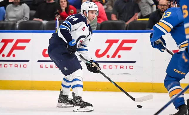 Winnipeg Jets' Josh Morrissey (44) handles the puck during the third period of an NHL hockey game against the St. Louis Blues, Thursday, April 9, 2026, in St. Louis. (AP Photo/Connor Hamilton)