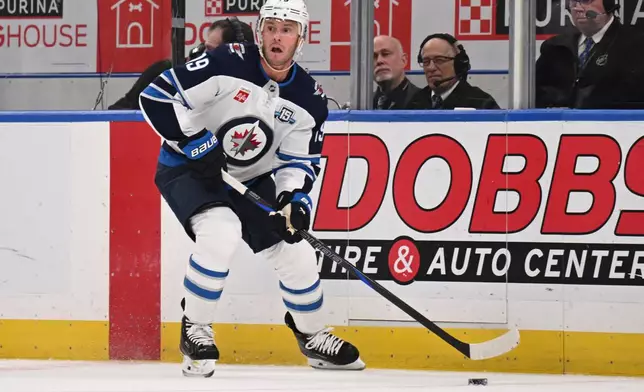 Winnipeg Jets' Jonathan Toews (19) controls the puck during the second period of an NHL hockey game against the St. Louis Blues, Thursday, April 9, 2026, in St. Louis. (AP Photo/Connor Hamilton)