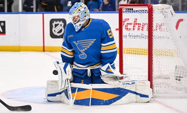St. Louis Blues goaltender Jordan Binnington (50) makes a save during the third period of an NHL hockey game against the Winnipeg Jets Thursday, April 9, 2026, in St. Louis. (AP Photo/Connor Hamilton)