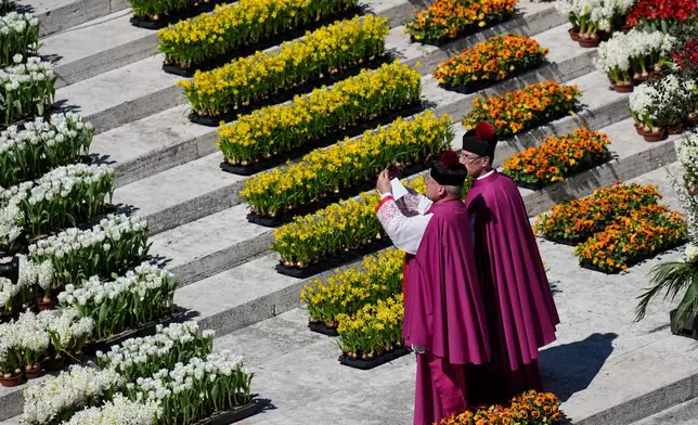 Pope Leo XIV delivers the Urbi et Orbi blessing - Latin for "to the city of Rome and to the world" - from the central loggia of St. Peter's Basilica at the end of Easter Mass he presided over in St. Peter's Square at the Vatican, Sunday, April 5, 2026. (AP Photo/Alessandra Tarantino)