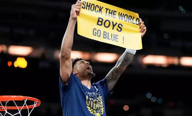 Michigan forward Yaxel Lendeborg celebrates after defeating UConn in the NCAA college basketball tournament national championship game at the Final Four, Monday, April 6, 2026, in Indianapolis. (AP Photo/Abbie Parr)