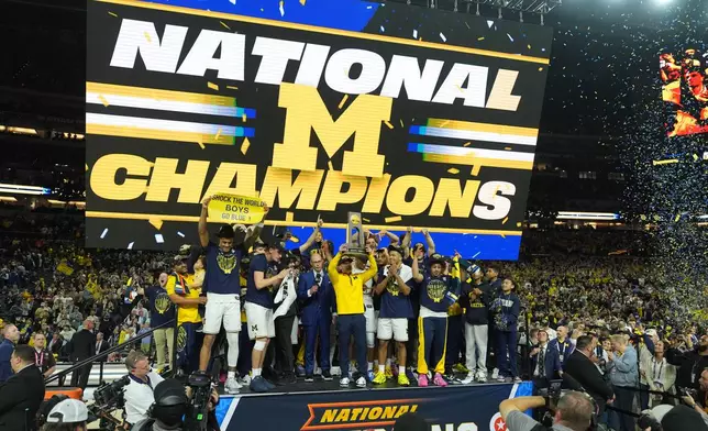 Michigan celebrates after defeating UConn in the NCAA college basketball tournament national championship game at the Final Four, Monday, April 6, 2026, in Indianapolis. (AP Photo/Michael Conroy)