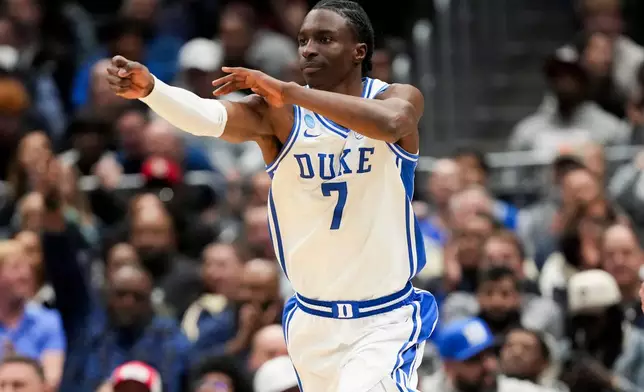 Duke guard Dame Sarr celebrates a basket against UConn during the first half in the Elite Eight of the NCAA college basketball tournament, Sunday, March 29, 2026, in Washington. (AP Photo/Stephanie Scarbrough)