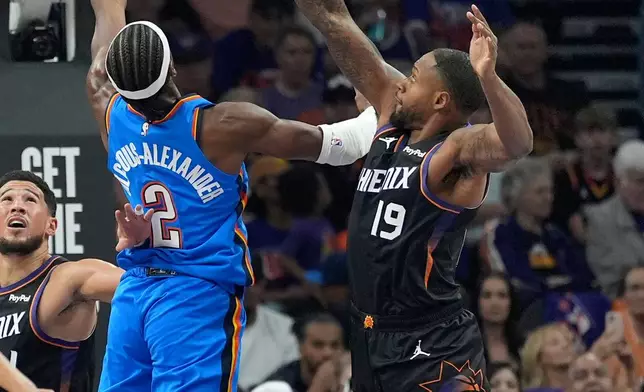 Oklahoma City Thunder guard Shai Gilgeous-Alexander (2) scores against Phoenix Suns forward Haywood Highsmith (19) during the first half of Game 3 of a first-round NBA playoffs basketball series, Saturday, April 25, 2026, in Phoenix. (AP Photo/Ross D. Franklin)