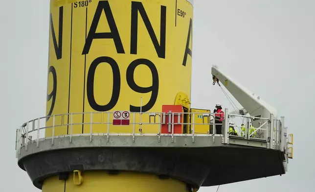 People work on a turbine at South Fork Wind offshore wind farm off the coast of Block Island, R.I., Thursday, April 23, 2026. (AP Photo/Joshua A. Bickel)