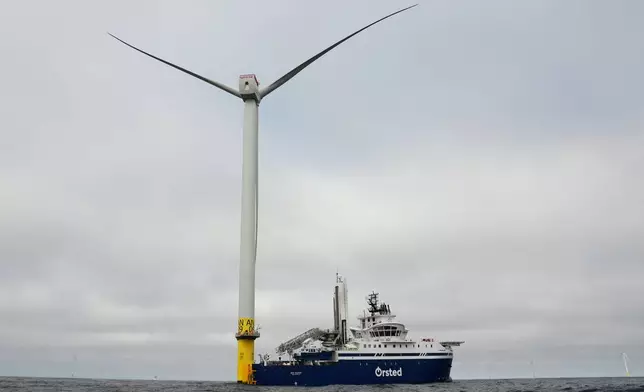 People work on a turbine near an Orsted boat at South Fork Wind offshore wind farm off the coast of Block Island, R.I., Thursday, April 23, 2026. (AP Photo/Joshua A. Bickel)