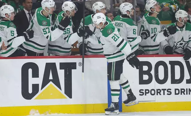 Dallas Stars left wing Jason Robertson is congratulated at the bench after scoring a goal against the Minnesota Wild during the first period of Game 4 in the first round of the NHL Stanley Cup hockey playoffs Saturday, April 25, 2026, in St. Paul, Minn. (AP Photo/Matt Krohn)