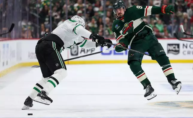 Minnesota Wild left wing Marcus Johansson, right, and Dallas Stars defenseman Nils Lundkvist, left, collide during the third period of Game 4 in the first round of the NHL Stanley Cup hockey playoffs Saturday, April 25, 2026, in St. Paul, Minn. (AP Photo/Matt Krohn)