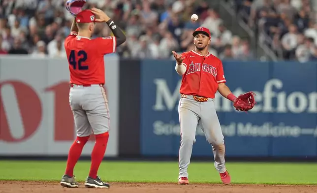 Los Angeles Angels' Zach Neto, left, and Oswald Peraza, right, react after a ball dropped between them allowing a single for New York Yankees' Jazz Chisholm Jr. during the ninth inning of a baseball game Wednesday, April 15, 2026, in New York. (AP Photo/Frank Franklin II)