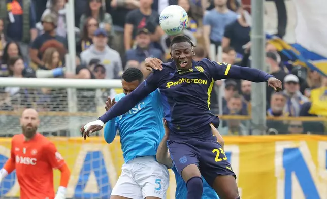 Parma's Nesta Elphege and Napoli's Juan Jesus, left, vie for the ball during the Serie A soccer match between Parma and Napoli, in Parma, Italy, Sunday, April 12, 2026. (Alberto Mariani/LaPresse via AP)