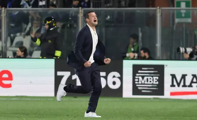 Inter Milan's head coach Cristian Chivu celebrates during the Serie A soccer match between Como and Inter, in Como, Italy, Sunday, April 12, 2026. (Antonio Saiai/LaPresse via AP)