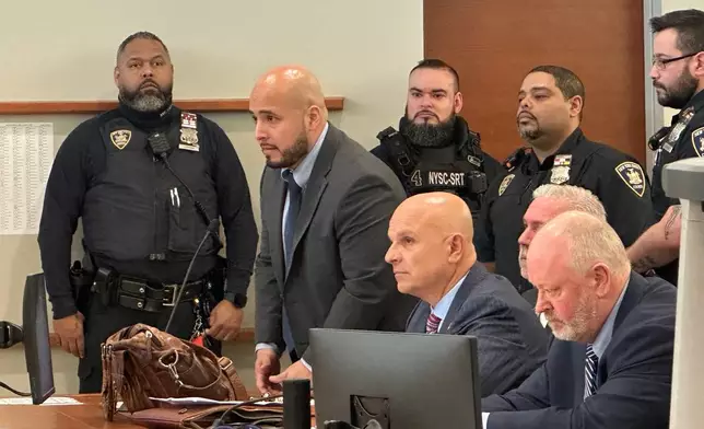Former New York City police sergeant Erik Duran stands during his sentencing hearing at the Bronx County Hall of Justice Thursday, April 9, 2026, New York, for tossing a picnic cooler full of drinks at a fleeing suspect, Eric Duprey, who then crashed his motorized scooter and died. (AP Photo/Michael R. Sisak)