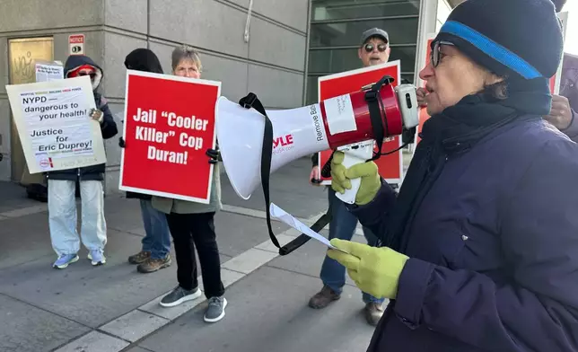 Demonstrators stand outside the Bronx County Hall of Justice in New York, Thursday, April 9, 2026, where former New York City police sergeant Erik Duran is set to be sentenced for tossing a picnic cooler full of drinks at a fleeing suspect, Eric Duprey, who then crashed his motorized scooter and died. (AP Photo/David Martin)