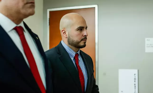 FILE - New York police officer Erik Duran, who is charged with hurling a plastic cooler at a man fleeing officers on a motorized scooter, causing a crash that killed the driver, arrives to his manslaughter trial at the Bronx Criminal Court in New York, Feb. 6, 2026. (AP Photo/Kena Betancur, File)