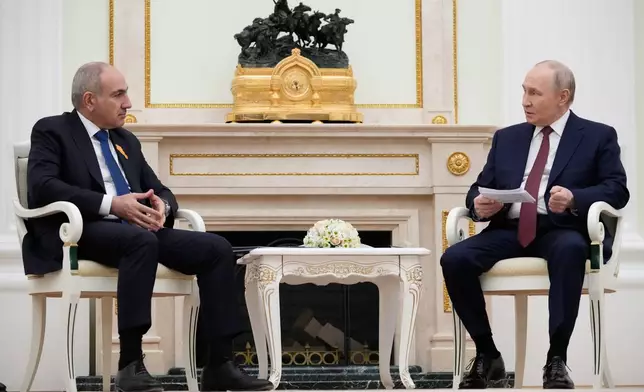 Russian President Vladimir Putin, right, speaks with Armenian Prime Minister Nikol Pashinyan at the Kremlin in Moscow, Wednesday, April 1, 2026. (AP Photo/Pavel Bednyakov, Pool)