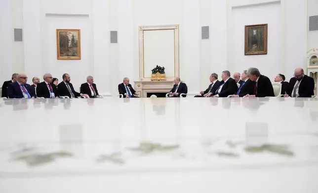 Russian President Vladimir Putin, center right, and Armenian Prime Minister Nikol Pashinyan, center left, hold talks at the Kremlin in Moscow, Wednesday, April 1, 2026. (AP Photo/Pavel Bednyakov, Pool)