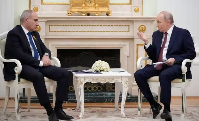 Russian President Vladimir Putin, right, and Armenian Prime Minister Nikol Pashinyan talk during their meeting at the Kremlin in Moscow, Russia, Wednesday, April 1, 2026. (AP Photo/Pavel Bednyakov, Pool)