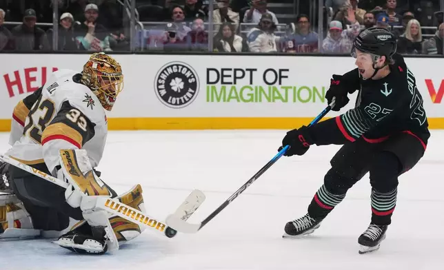 Seattle Kraken center Berkly Catton makes the winning shot against Vegas Golden Knights goaltender Adin Hill during a shootout in an NHL hockey game Thursday, April 9, 2026, in Seattle. (AP Photo/Lindsey Wasson)