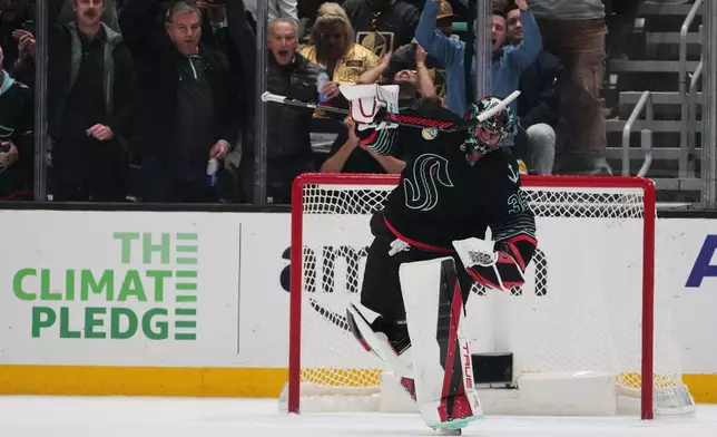 Seattle Kraken goaltender Joey Daccord reacts to making a save against Vegas Golden Knights right wing Pavel Dorofeyev in a shootout for the win in an NHL hockey game Thursday, April 9, 2026, in Seattle. (AP Photo/Lindsey Wasson)