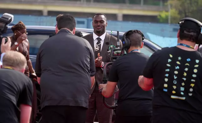 Notre Dame running back Jeremiyah Love arrives on the red carpet before the first round of the NFL football draft, Thursday, April 23, 2026, in Pittsburgh. (AP Photo/Gene J. Puskar)