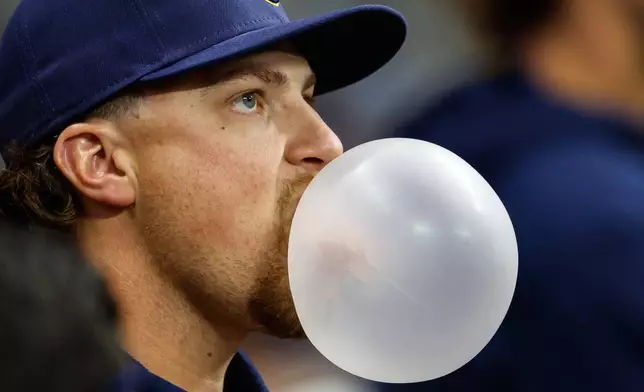 Milwaukee Brewers' Chad Patrick blows a gum bubble in the dugout during the eighth inning of a baseball game against the Pittsburgh Pirates, Saturday, April 25, 2026, in Milwaukee. (AP Photo/Jeffrey Phelps)
