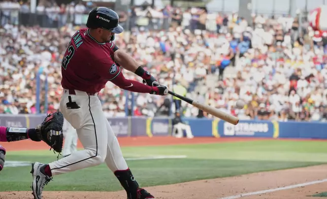 Arizona Diamondbacks' Tim Tawa hits a grand slam against the San Diego Padres during the seventh inning of a baseball game in Mexico City, Sunday, April 26, 2026. (AP Photo/Fernando Llano)