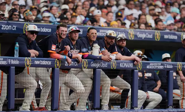 Players of the San Diego Padres stand at the dugout during the eighth inning of a baseball game against the Arizona Diamondbacks in Mexico City, Sunday, April 26, 2026. (AP Photo/Fernando Llano)