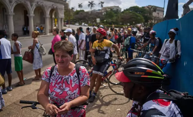 Commuters wait for the arrival of a public bus in Havana, Wednesday, April 8, 2026. (AP Photo/Ramon Espinosa)