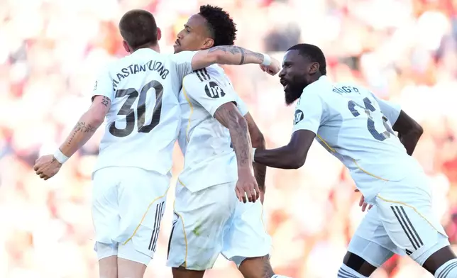 Real Madrid's Franco Mastantuono, left, Eder Militao, center, and Antonio Rudiger celebrate after a goal during a La Liga soccer match between Mallorca and Real Madrid in Palma de Mallorca, Spain, Saturday, April 4, 2026. (AP Photo/Jose Breton)