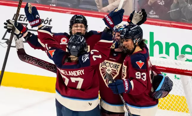 Montreal Victoire goaltender Ann-Renee Desbiens (35) celebrates with teammates after defeating the Seattle Torrent in a PWHL hockey game in Laval, Quebec, on Tuesday, April 7, 2026. (Christopher Katsarov/The Canadian Press via AP)