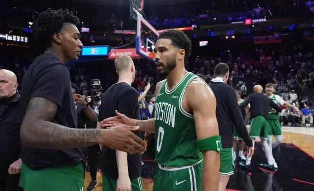Boston Celtics' Jayson Tatum celebrates with teammates after the Celtics won Game 3 against the Philadelphia 76ers in a first-round NBA playoffs basketball series Friday, April 24, 2026, in Philadelphia. (AP Photo/Matt Slocum)