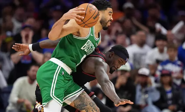 Boston Celtics' Jayson Tatum, left, tries to get past Philadelphia 76ers' Adem Bona during the second half of Game 3 in a first-round NBA playoffs basketball series Friday, April 24, 2026, in Philadelphia. (AP Photo/Matt Slocum)