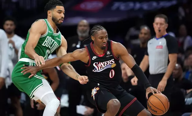 Philadelphia 76ers' Tyrese Maxey, right, tries to get past Boston Celtics' Jayson Tatum during the first half of Game 3 in a first-round NBA playoffs basketball series Friday, April 24, 2026, in Philadelphia. (AP Photo/Matt Slocum)