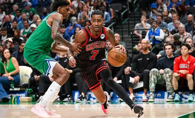 Chicago Bulls' Rob Dillingham drives against Dallas Mavericks' AJ Johnson during an NBA basketball game Sunday, April 12, 2026, in Dallas. (AP Photo/Albert Pena)
