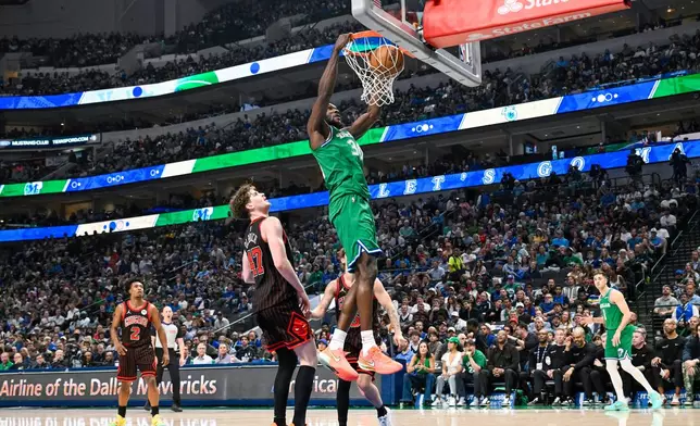 Dallas Mavericks' Moussa Cisse, center top, dunks over Chicago Bulls center Lachlan Olbrich during an NBA basketball game against the Chicago Bulls, Sunday, April 12, 2026, in Dallas. (AP Photo/Albert Pena)