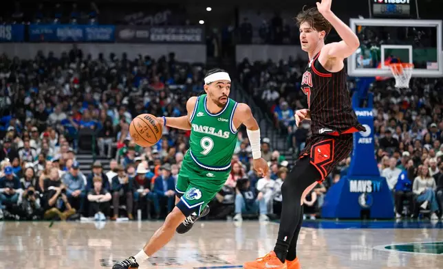 Dallas Mavericks' Ryan Nembhard drives against Chicago Bulls' Lachlan Olbrich during an NBA basketball game Sunday, April 12, 2026, in Dallas. (AP Photo/Albert Pena)