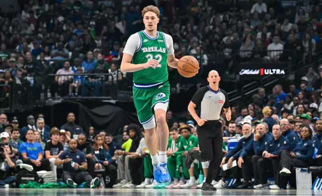 Dallas Mavericks' Cooper Flagg brings the ball up court during an NBA basketball game against the Chicago Bulls Sunday, April 12, 2026, in Dallas. (AP Photo/Albert Pena)