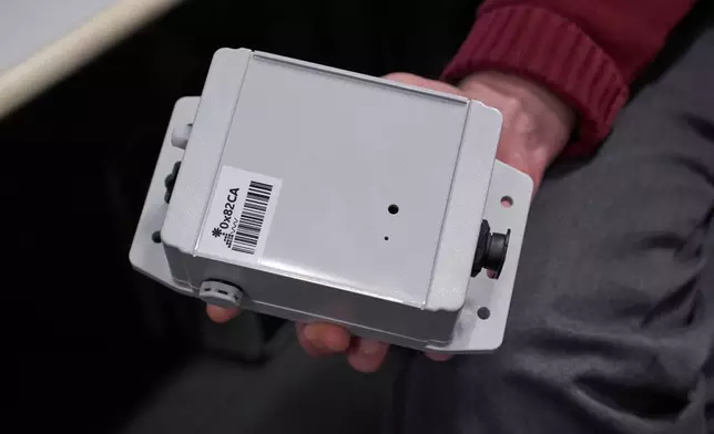 Brian Mayton, a member of the Living Observatory and research affiliate at Massachusetts Institute of Technology Media Lab, holds a prototype of a sensor meant to collect ecological data from wetlands Wednesday, March 25, 2026, at MIT in Cambridge Mass. (Jamie Jiang/MIT Graduate Program in Science Writing via AP)